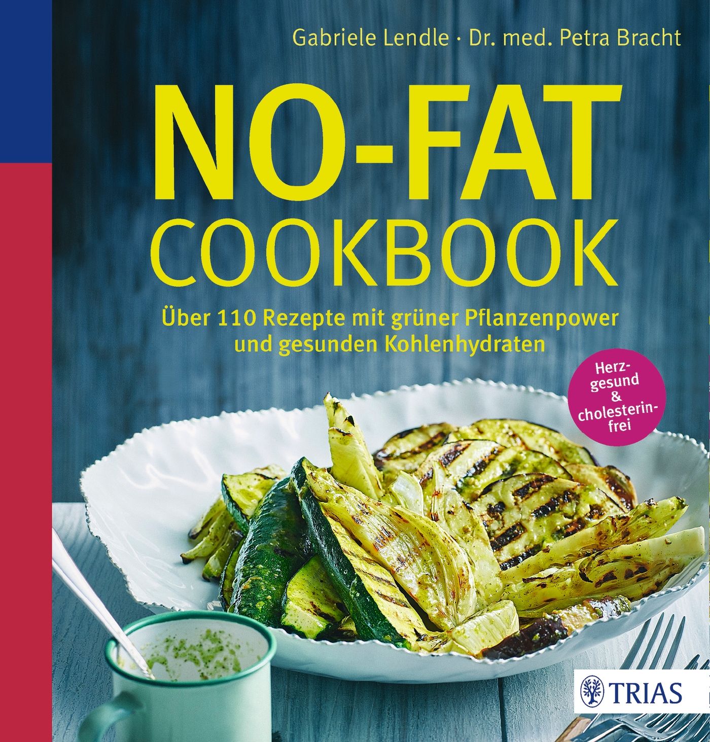 Kochbuch mit dem Titel NO-FAT COOKBOOK. Auf dem Cover sind gegrilltes Gemüse und ein Teller abgebildet. Der Titel ist gelb.