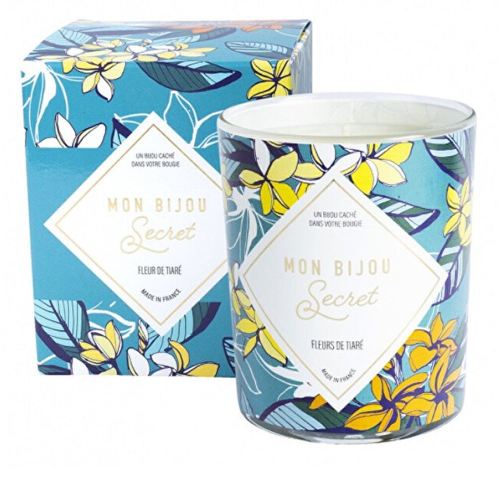Zylinderförmige Kerze mit floralem Muster und Verpackung. Aufschrift "Mon Bijou Secret, Fleurs de Tiaré".