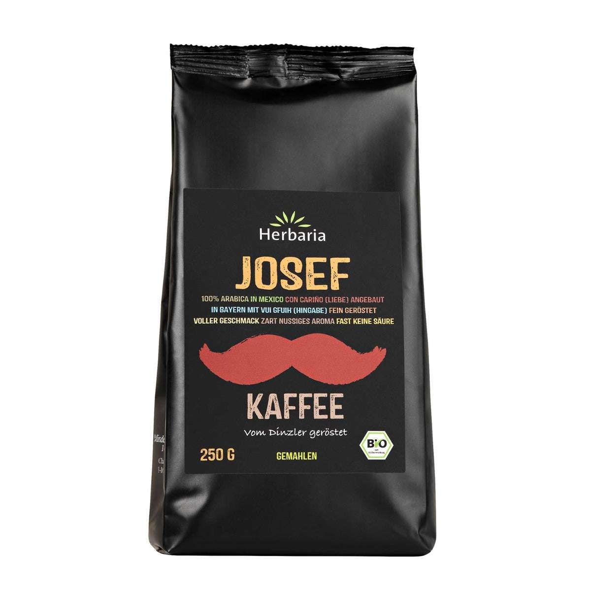 Schwarzer Beutel mit Aufdruck. Auf dem Etikett: "Herbaria Josef Kaffee", roter Schnurrbart, Bio-Siegel. 250g.
