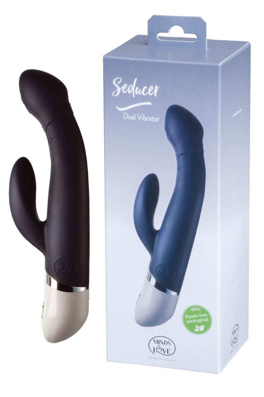 Dunkelblauer Vibrator neben Verpackung. Aufschrift: Seducer Dual Vibrator. Marke: MINDS of LOVE. Verpackung mit Aufhänger.
