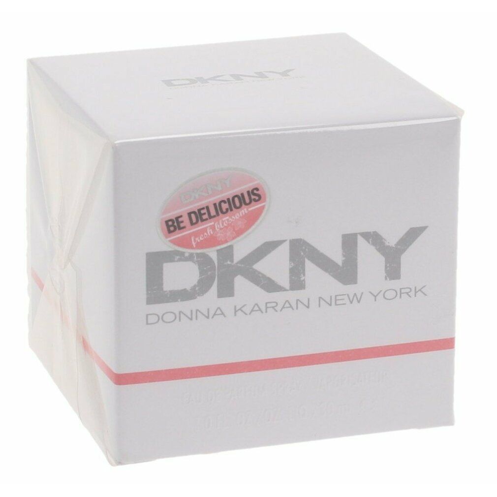 Weißer quadratischer Karton mit DKNY-Logo und Aufkleber Be Delicious fresh blossom. Text: Donna Karan New York.