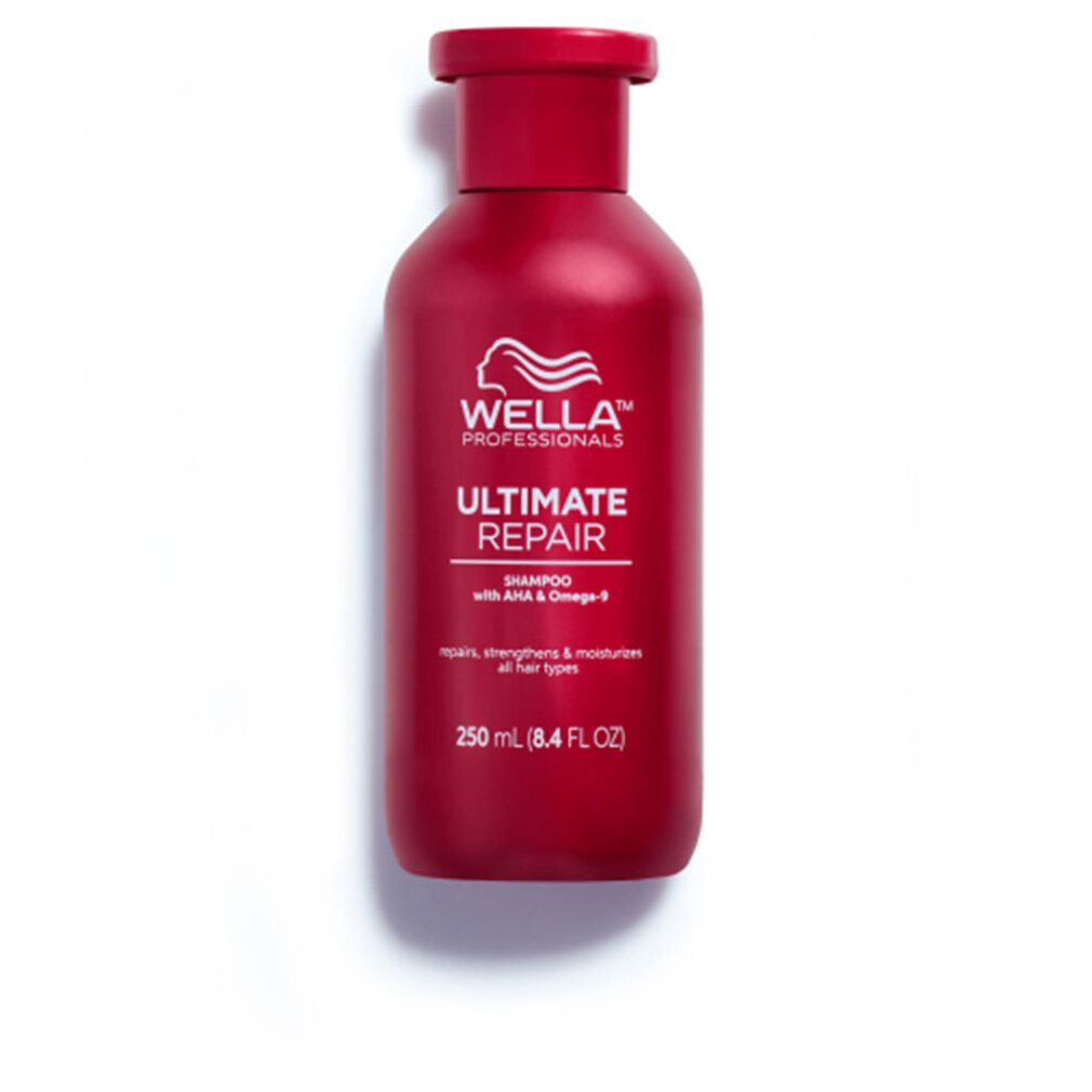Rote Shampoo-Flasche mit weißem Logo und Schriftzug 'Ultimate Repair'. Text: 'Shampoo mit AHA & Omega-9'. Auf weißem Hintergrund.