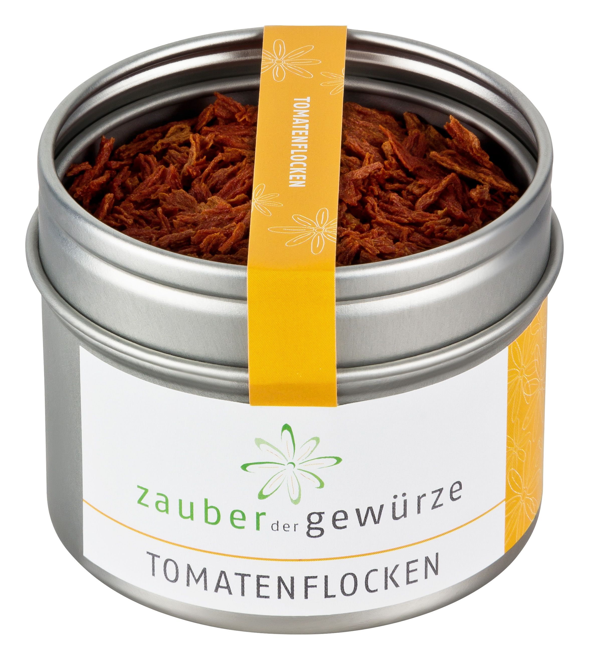 Metallbehälter mit Tomatenflocken. Gelbes Etikett mit Schriftzug. Produktname: Zauber der Gewürze Tomatenflocken.