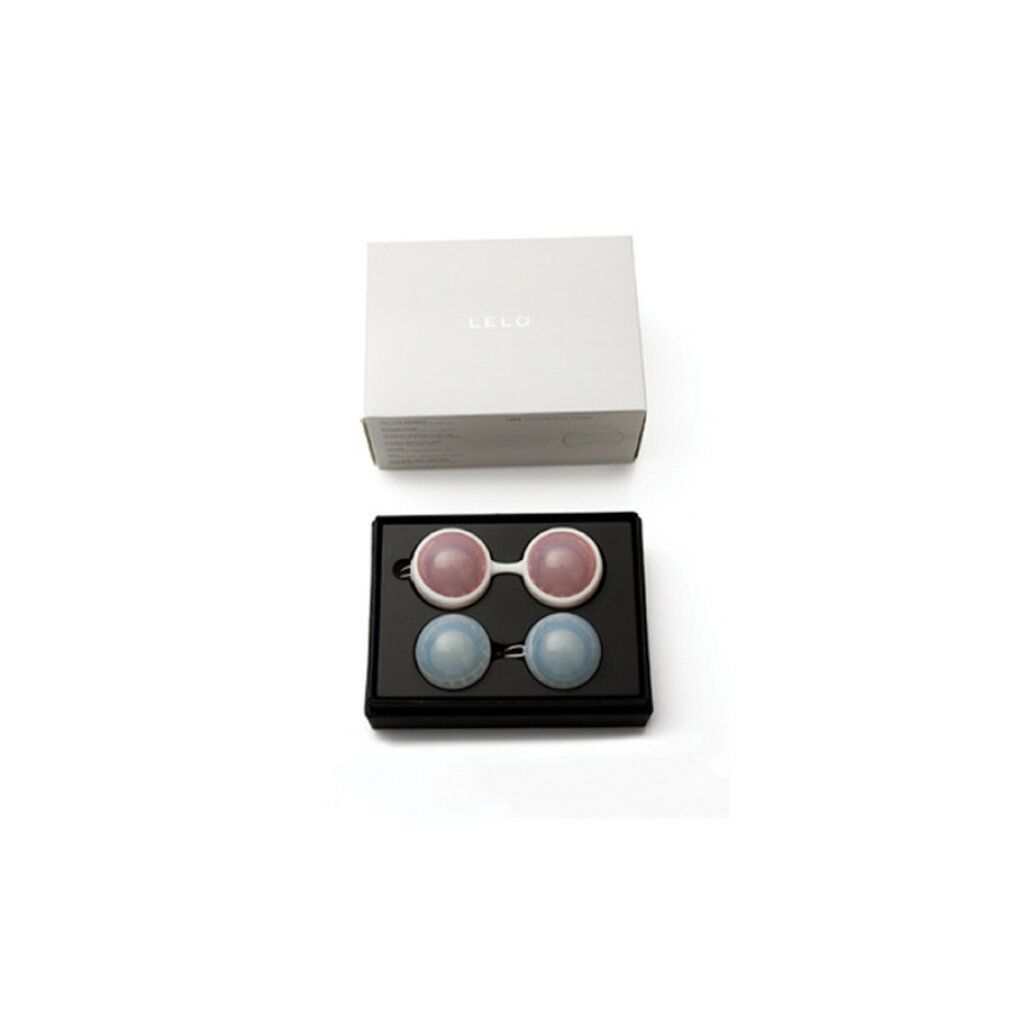 Weiße Box mit schwarzer Box. Zwei rosa und zwei blaue Kugeln. LELO Beads Classic.