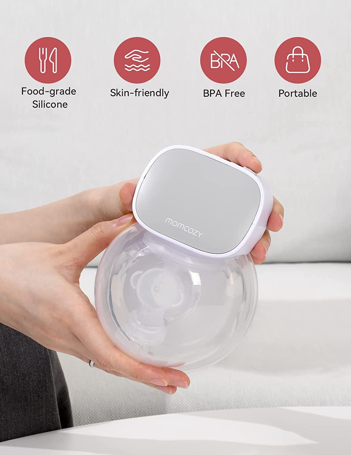 Hände halten elektrische Milchpumpe. Symbole: Lebensmittelqualität, hautfreundlich, BPA-frei, tragbar.