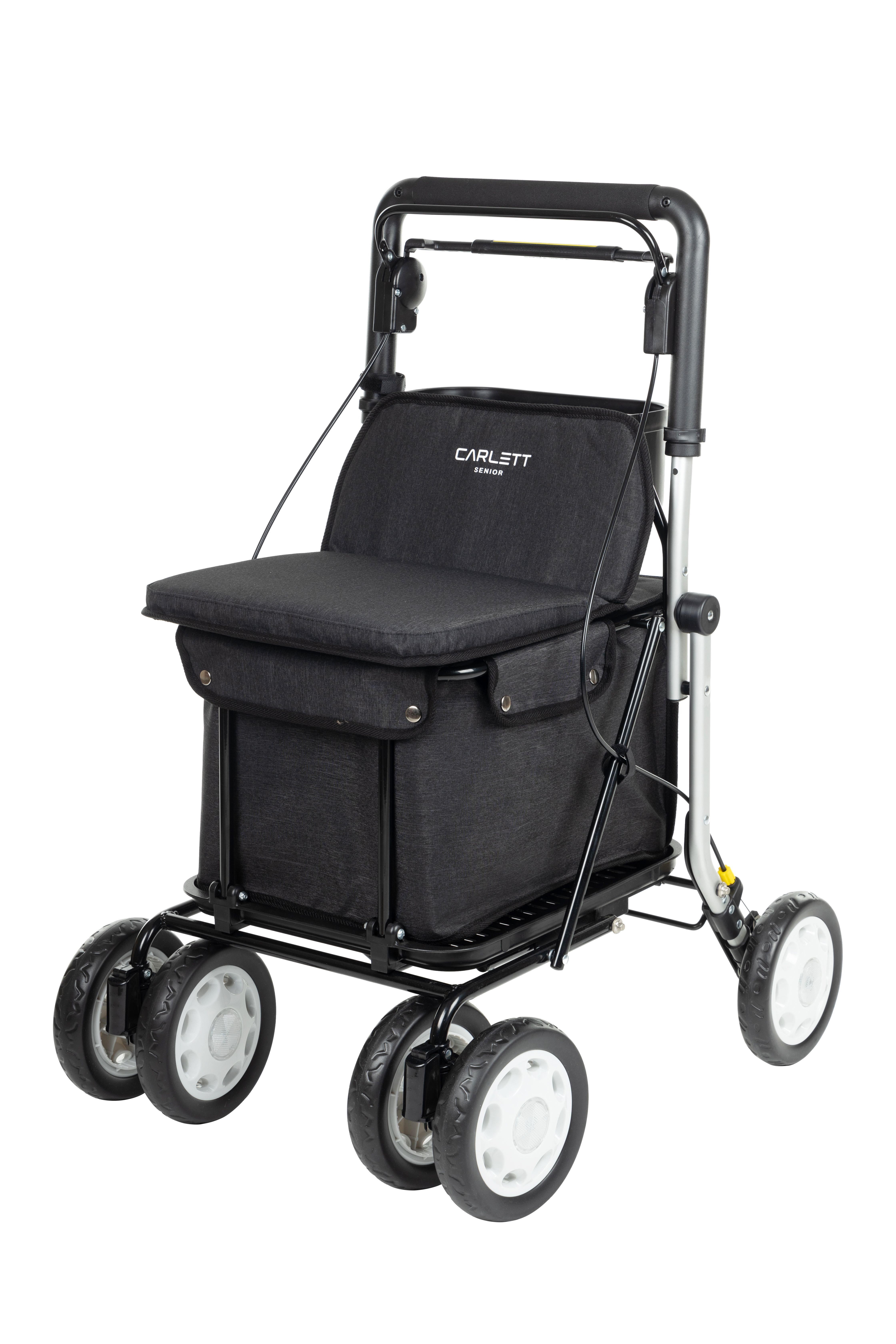 Gehstock mit Sitz und Einkaufstasche. Schwarzes Gestell, grauer Sitz und Tasche. Vier Räder mit weißen Felgen.