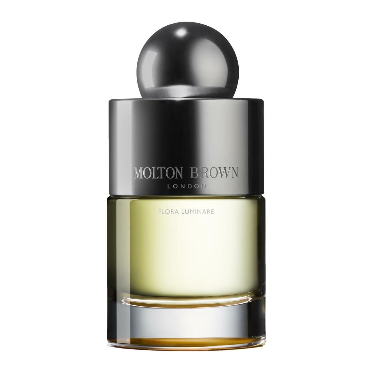 Parfümflakon mit silberfarbenem Verschluss. Aufschrift: Molton Brown London, Flora Luminare. Flüssigkeit gelblich.
