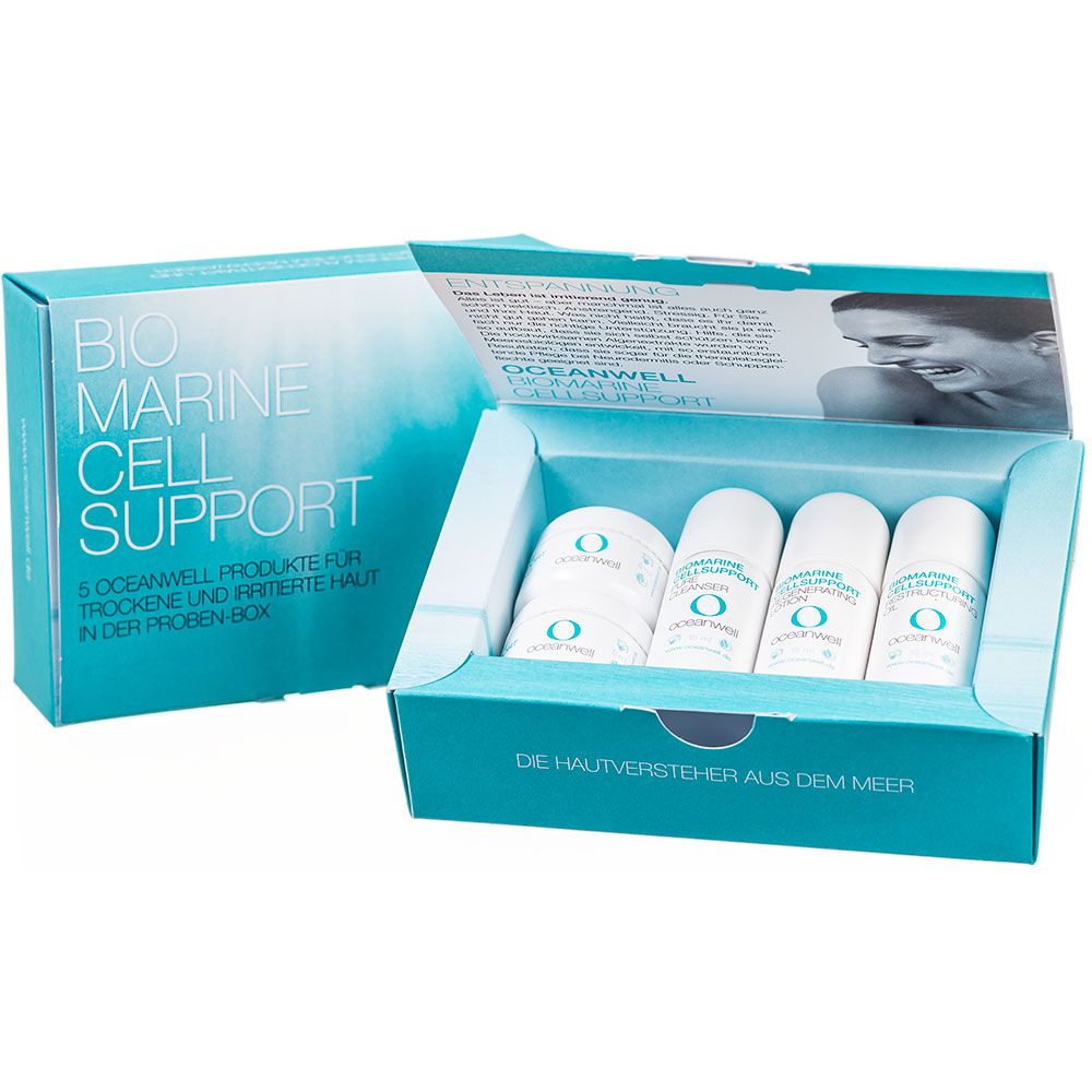 Offene Produktbox mit OCEANWELL-Produkten. Enthält kleine Flaschen und Tiegel. Aufschrift: BIO MARINE CELL SUPPORT. Text: 5 OCEANWELL Produkte für trockene und irritierte Haut.