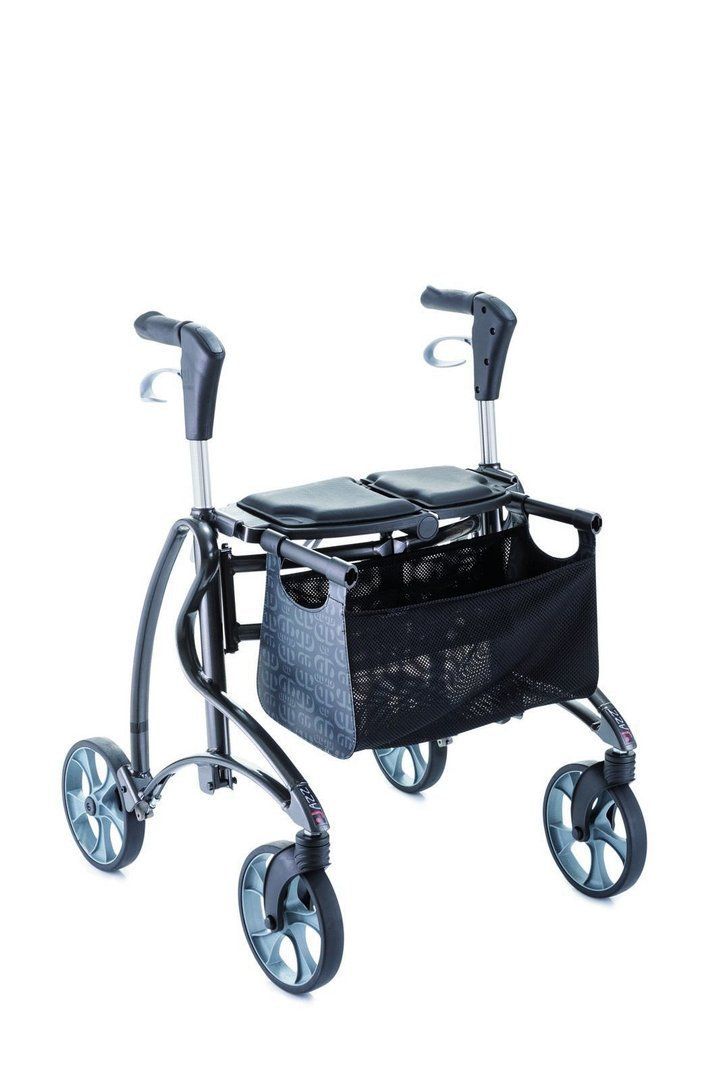 Rollator mit schwarzem Sitz, Korb und vier Rädern. Griffe und Rahmen in Grau. Schwarzer Korb mit Muster.