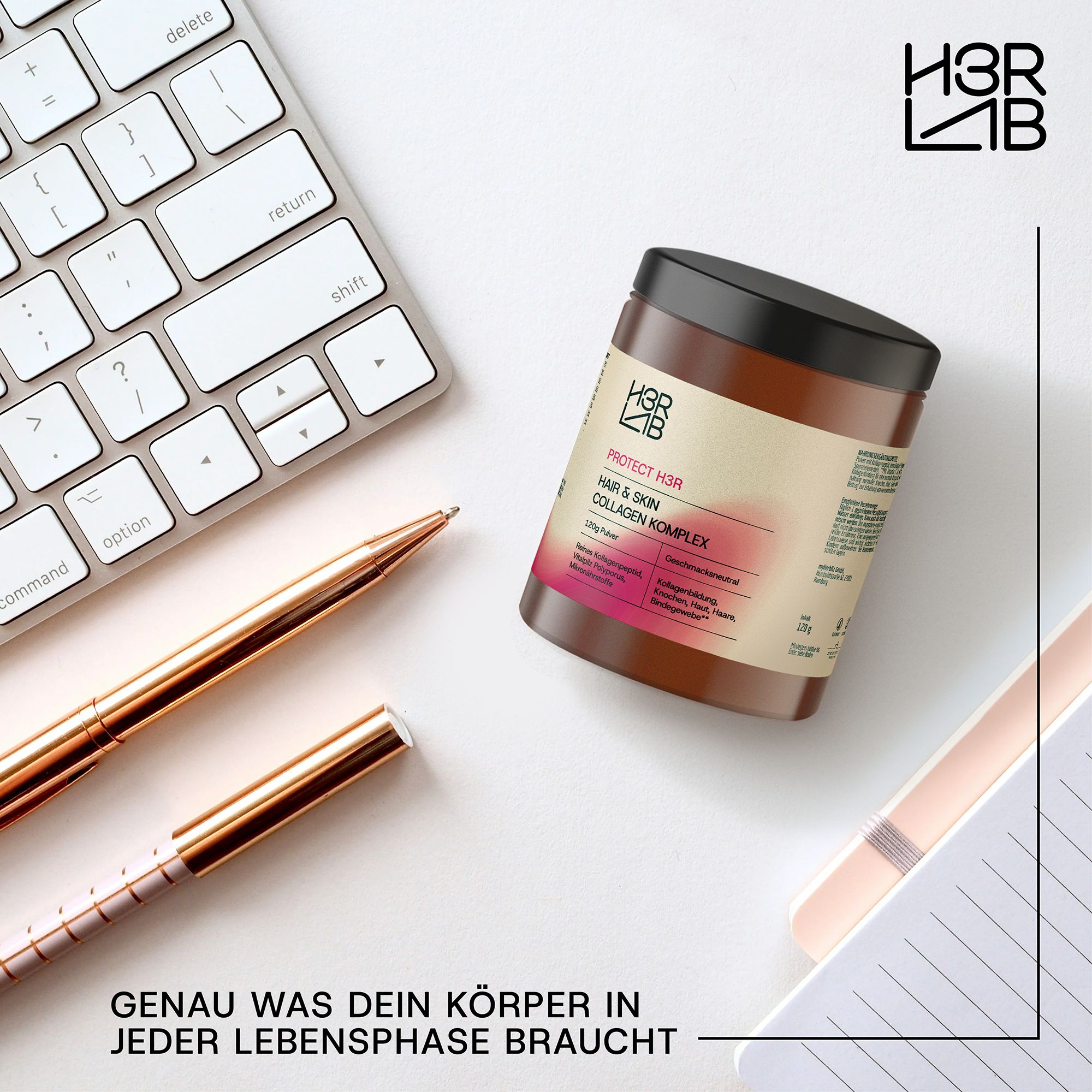 Braune Dose mit schwarzem Deckel. Aufschrift: H3R LAB Hair & Skin Kollagen Komplex. Auf Schreibtisch mit Stiften und Tastatur.
