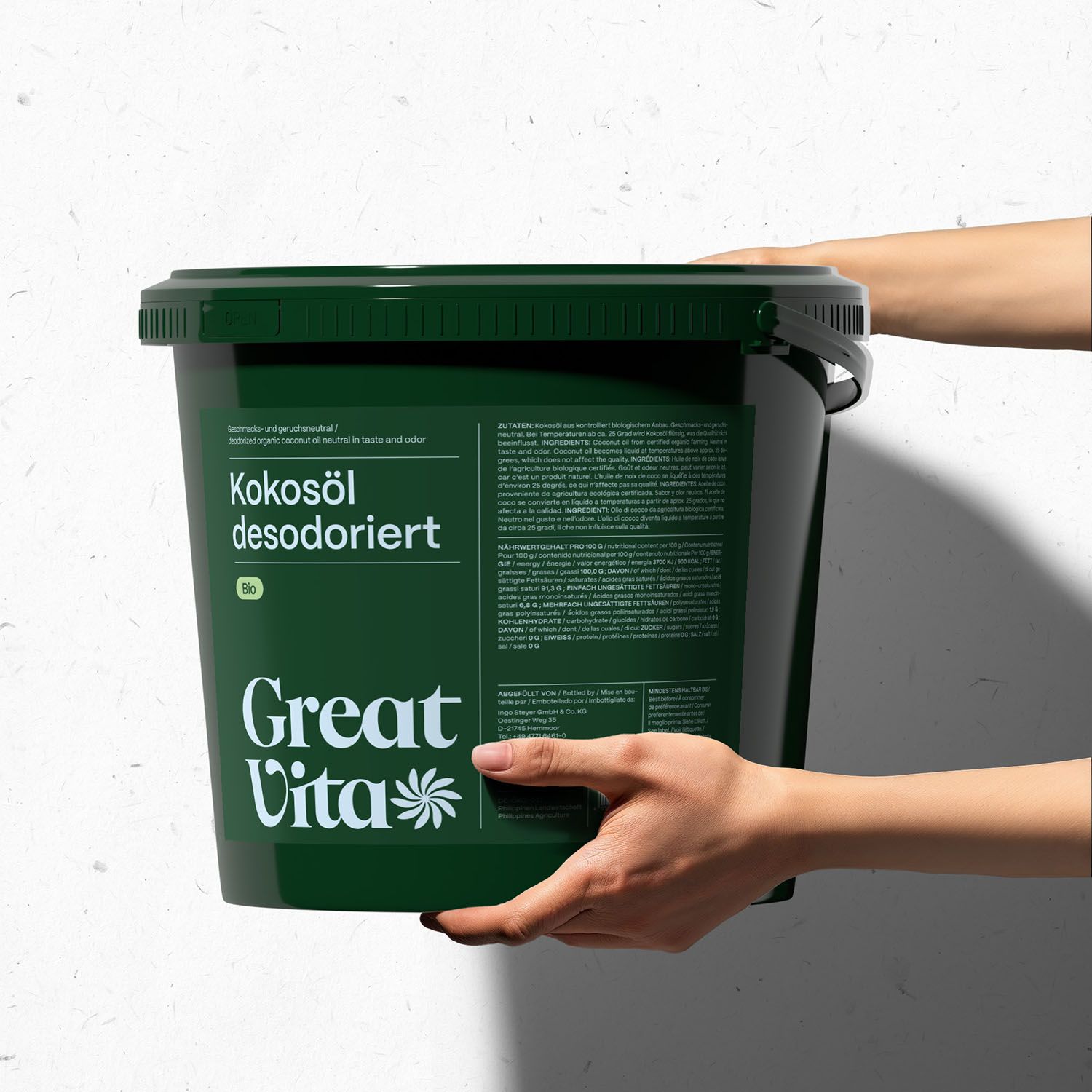 Grüner Eimer mit Deckel. Aufschrift: Kokosöl desodoriert, GreatVita. Hände halten den Eimer.