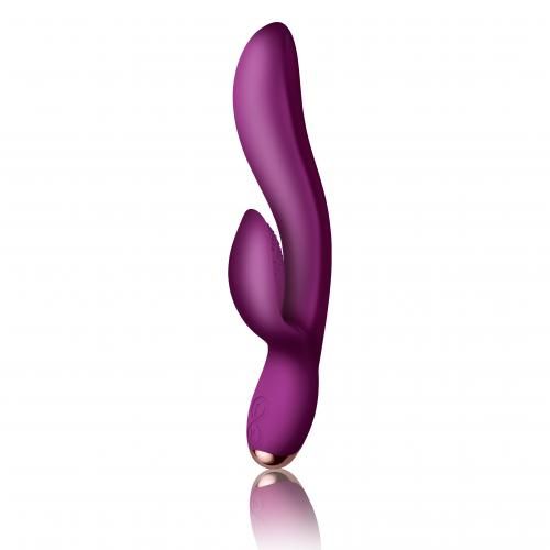 Fuchsienfarbener Vibrator mit geschwungener Form und abgerundeten Enden. Goldfarbener Akzent am unteren Ende.