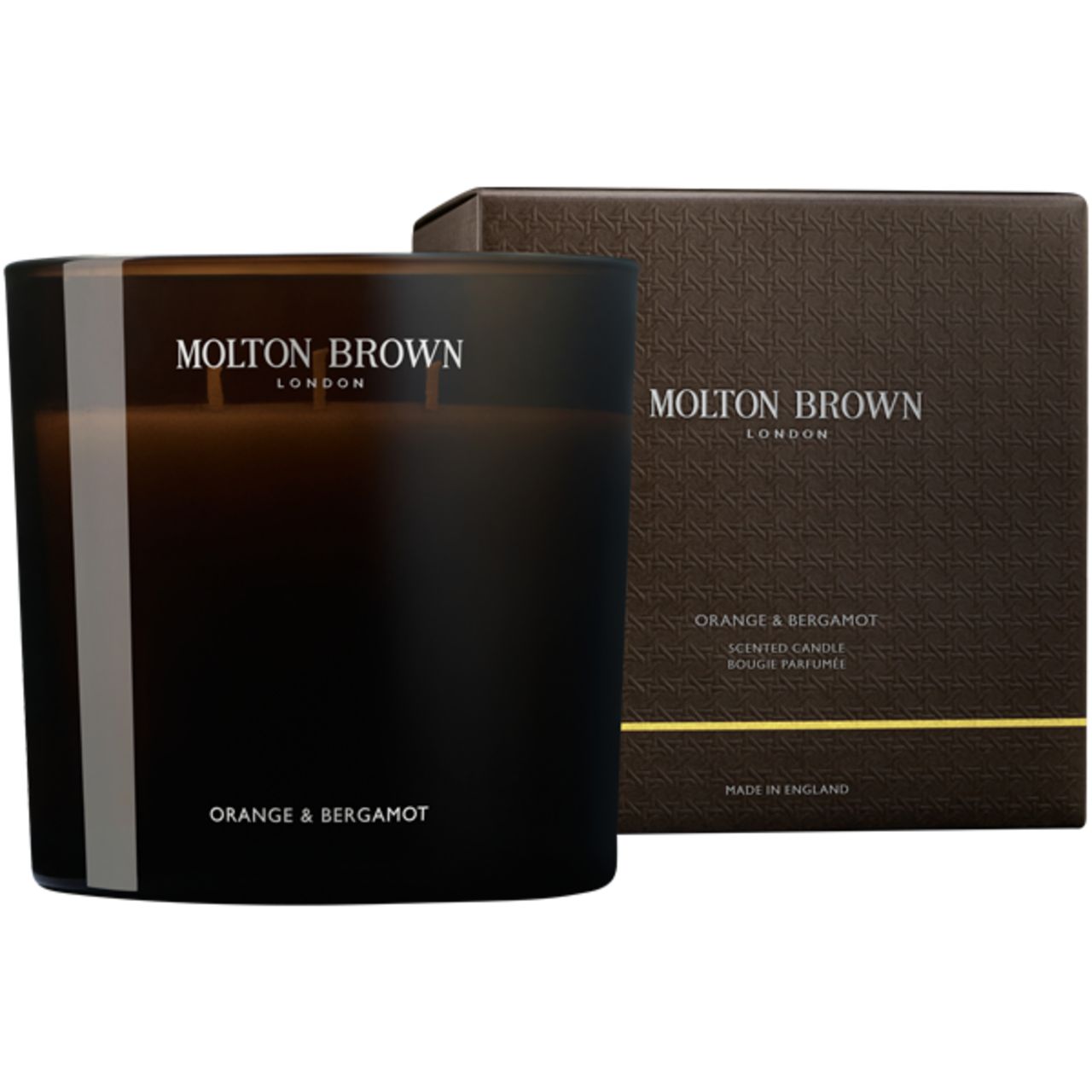 Duftkerze in dunkler Glasverpackung mit Box. Aufschrift: Molton Brown, Orange & Bergamot. Box mit Logo und Produktinformationen.