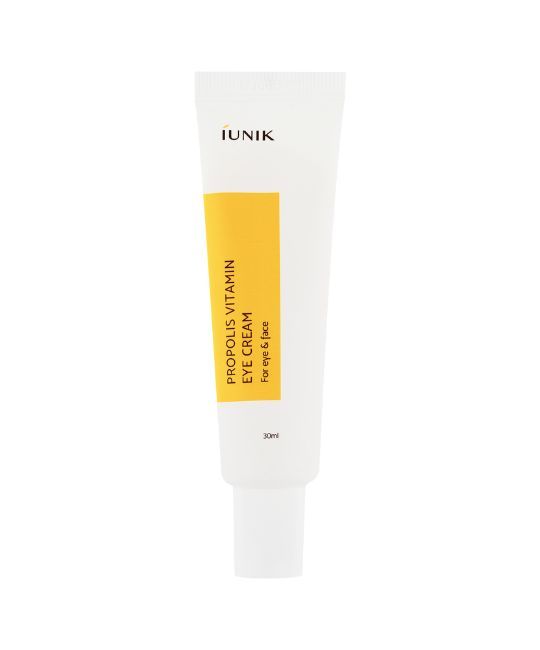 Weiße Tube mit gelbem Etikett. Aufschrift: IUNIK, PROPOLIS VITAMIN EYE CREAM, für Augen & Gesicht. 30ml.