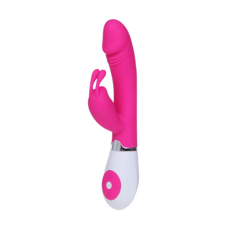 Rosa Vibrator mit weißem Sockel. Hat eine längliche Form mit einem erhabenen Teil und zwei kleineren Elementen.