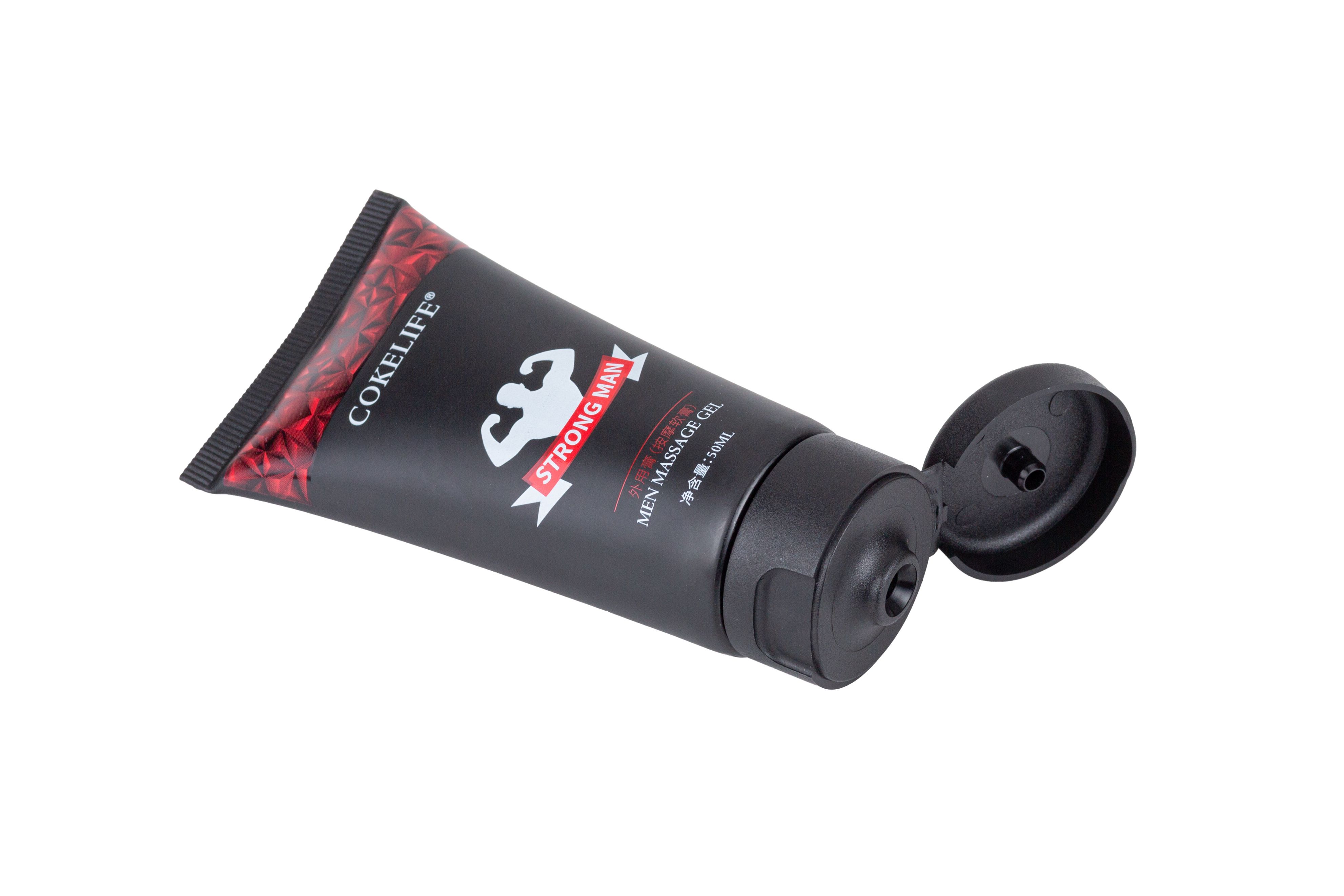 Schwarze Tube mit rotem Aufdruck und schwarzem Deckel. Aufschrift: COKELIFE STRONG MAN.