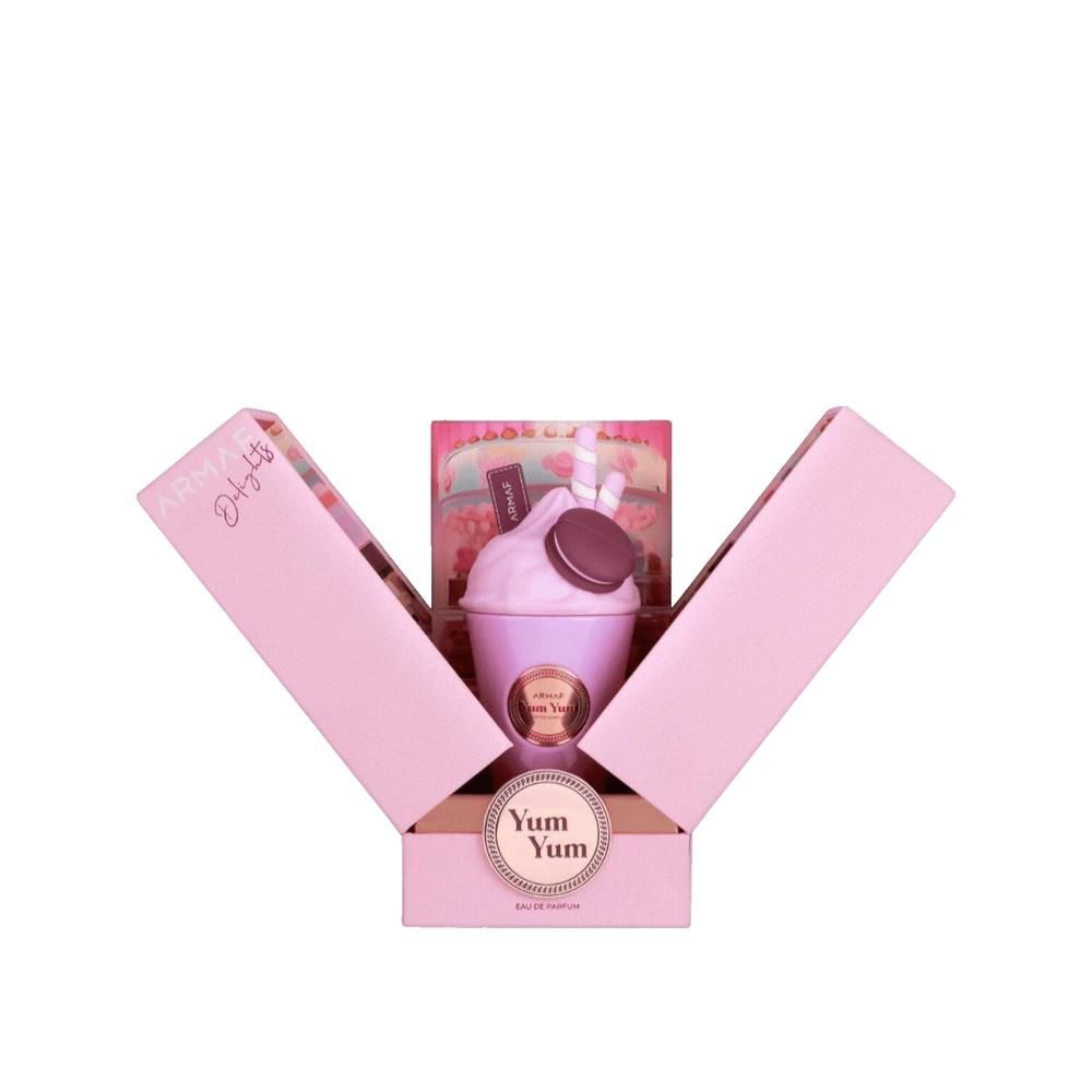 Produkt in rosa Geschenkbox. Flakon in Milchshake-Form mit Dekorationen. Aufschrift: Armaf Delights Yum Yum.