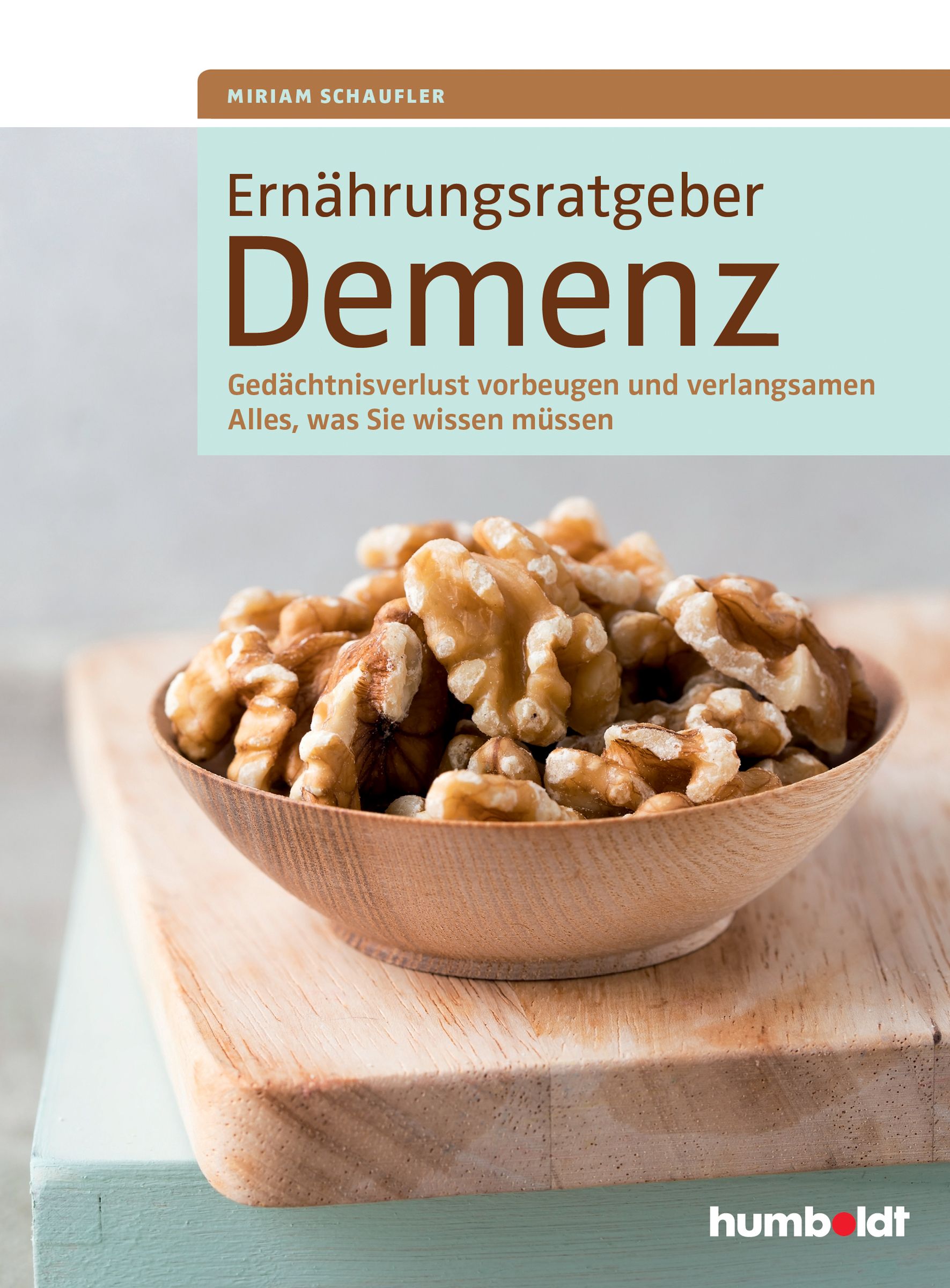 Buchcover: Ernährungsratgeber Demenz. Titel, Autor und Untertitel. Walnüsse in Holzschale auf Holzbrett.