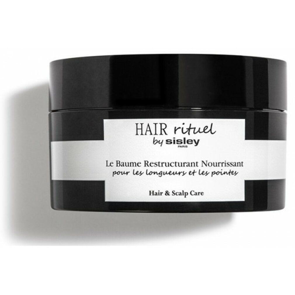 Schwarzer Tiegel mit weißem Etikett. Aufschrift: HAIR rituel by sisley PARIS. Le Baume Restructurant Nourrissant pour les longueurs et les pointes. Hair & Scalp Care.