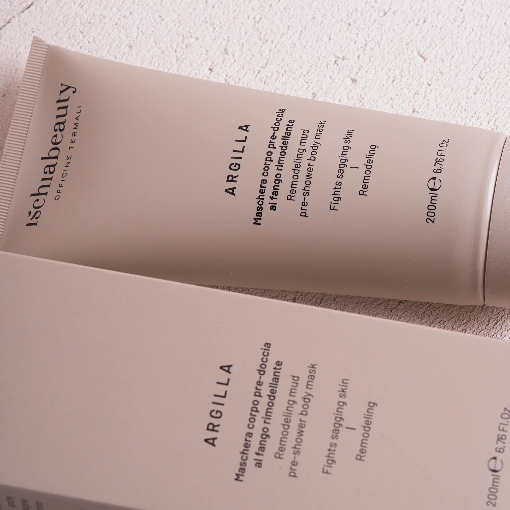 Tube und Schachtel. Aufschrift: Ischiabeauty, Argilla, Maschera corpo pre-doccia al fango rimodellante. Produkt liegt.