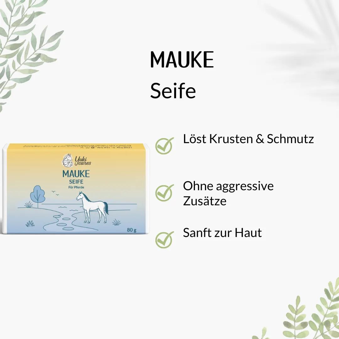 Rechteckige Seife mit Text: Mauke Seife. Text: Löst Krusten & Schmutz, Ohne aggressive Zusätze, Sanft zur Haut.