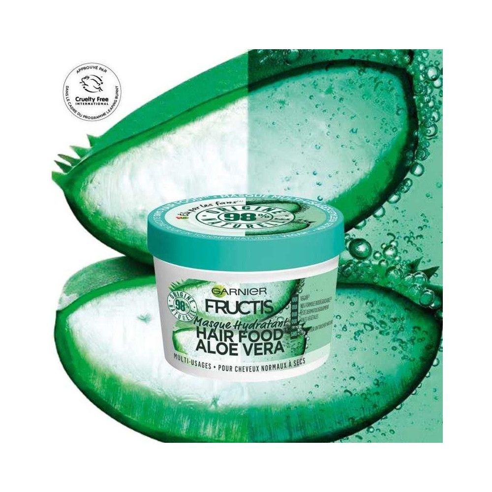 Haarmaske in weißem Tiegel mit grünem Deckel. Aufschrift: Garnier Fructis Hair Food Aloe Vera. Mit Aloe Vera. Cruelty Free-Logo.