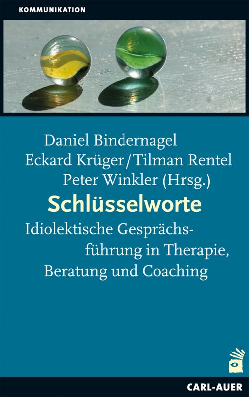 Buchcover mit Titel "Schlüsselworte". Autoren: Daniel Bindernagel, Eckard Krüger/Tilman Rentel, Peter Winkler. Zwei Murmeln auf glattem Untergrund.