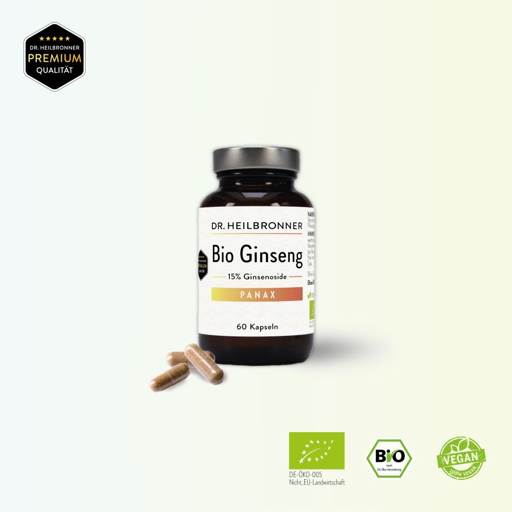 Braune Glasflasche mit weißem Etikett und Kapseln daneben. Aufschrift: Bio Ginseng, 15% Ginsenoside, PANAX, 60 Kapseln. Vegan.