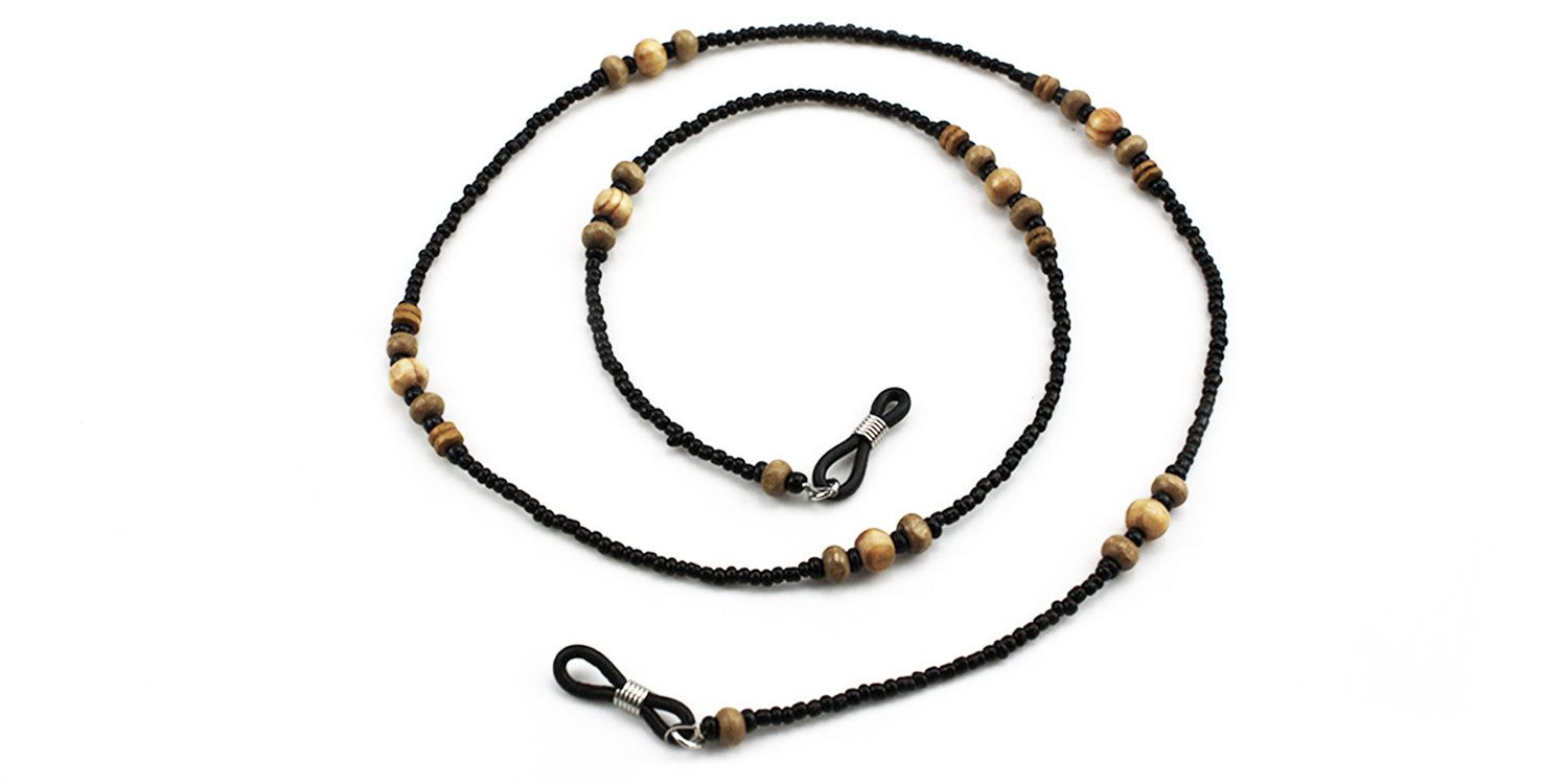 Brillenkette mit schwarzen Perlen und Holzperlen. Metallschlaufen zur Befestigung an der Brille.