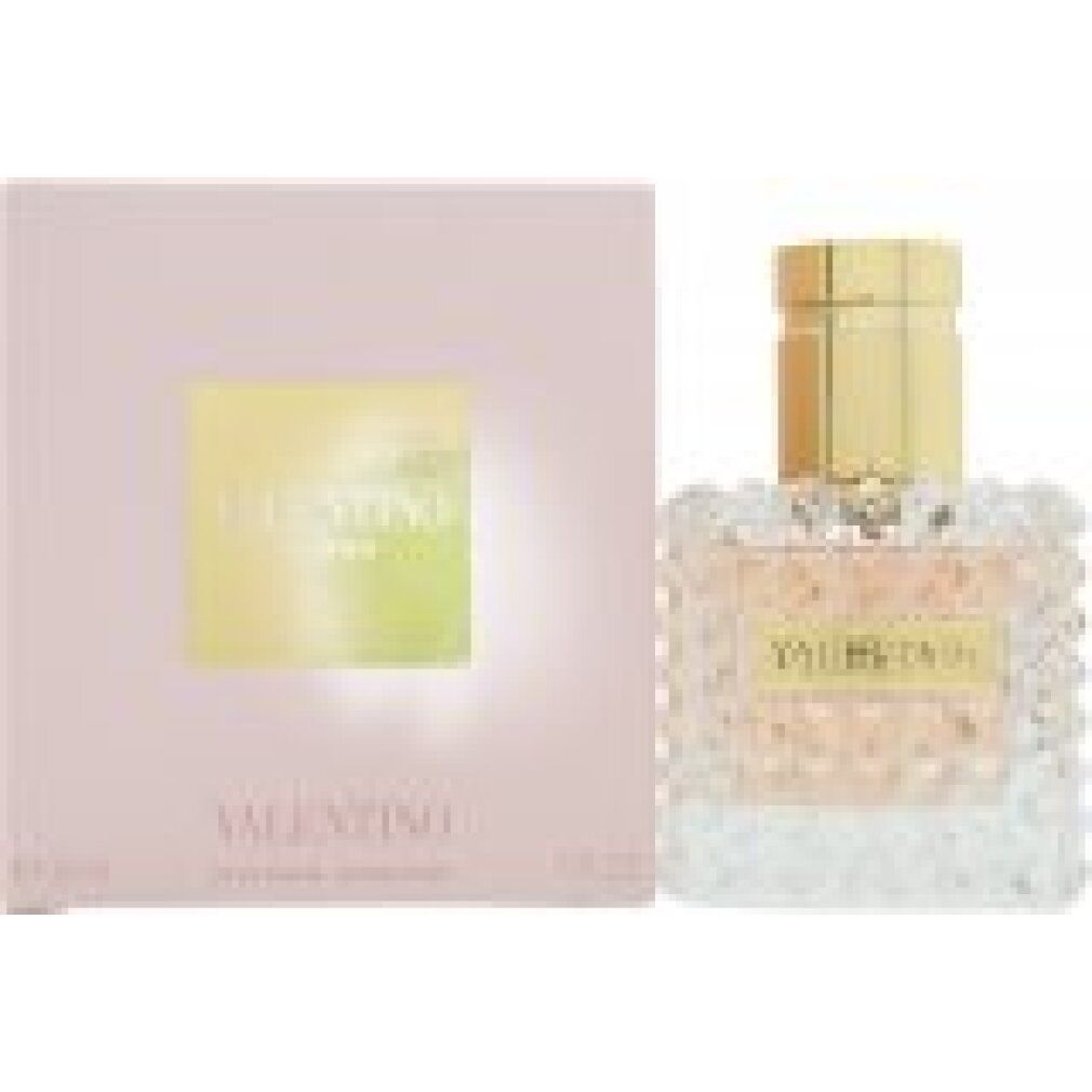 Flakon und Verpackung. Flakon quadratisch, goldfarbener Verschluss, Aufschrift VALENTINO. Rosa Flüssigkeit. Rosa Verpackung mit Logo.