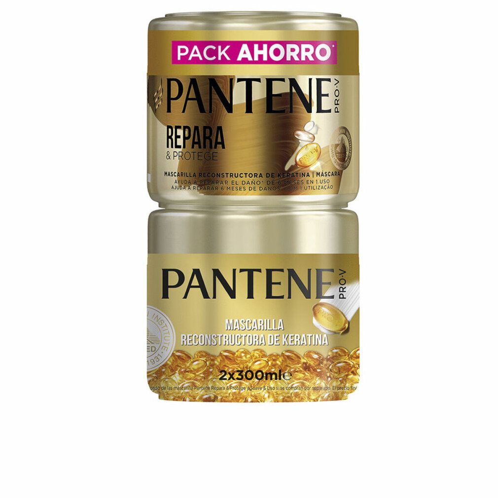 Zwei goldfarbene Tiegel, übereinander gestapelt. Aufschrift: PANTENE PRO-V, REPARIERT & SCHÜTZT. Auf dem unteren Tiegel: MASCHERA RECONSTRUCTORA DE KERATINA.