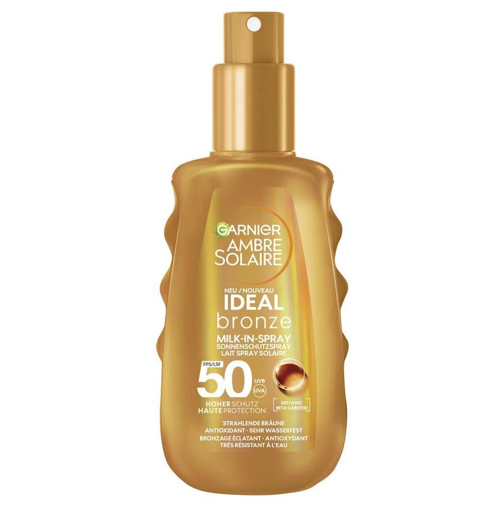 Garnier Ambre Solaire Ideal Bronze Milk-in-Spray 50. Braune Flasche mit Sprühkopf. Text: LSF 50, Milk-in-Spray, Sonnenschutz.