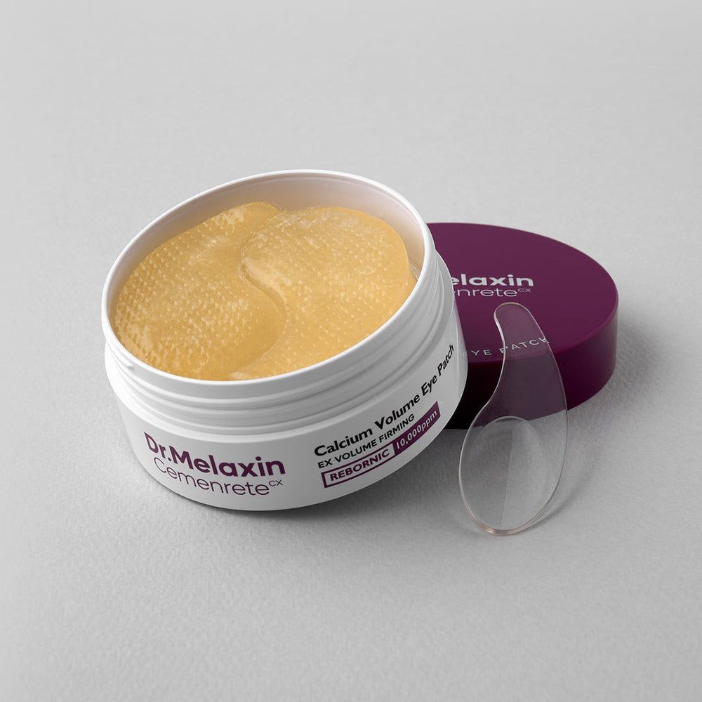 Dr. Melaxin Cemenrete Calcium Volume Eye Patch Behälter geöffnet mit gelben Augenpads und Spatel.