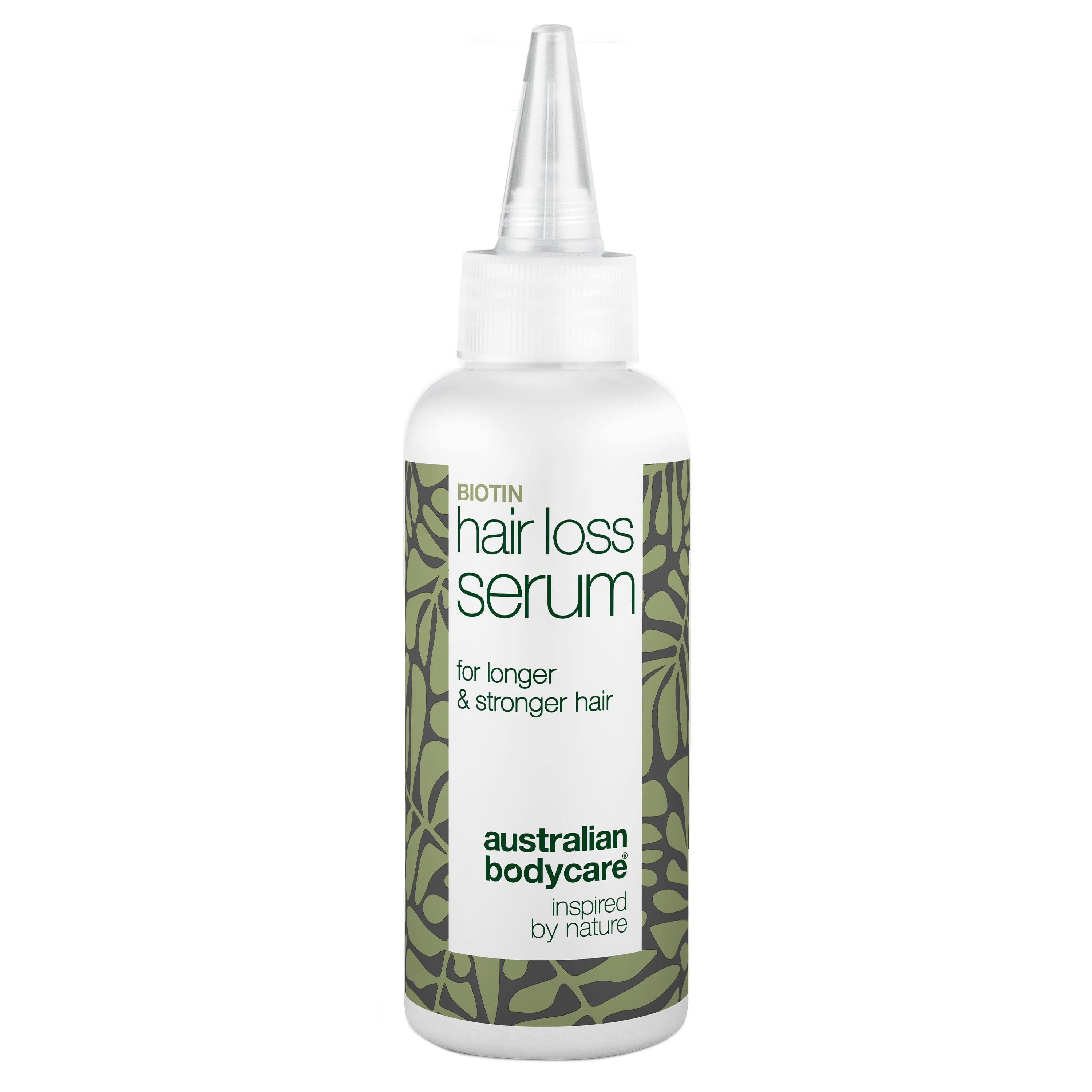 Flacone bianco di siero. Scritto: Hair Loss Serum, per capelli più lunghi e forti. Con applicatore.