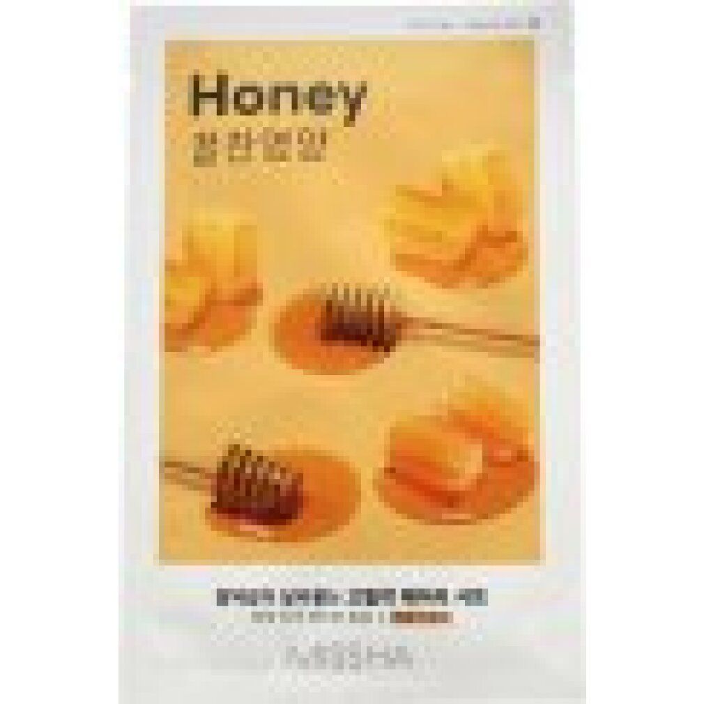 Gesichtsmaske mit Honig-Motiv. Verpackung mit Honigwaben und Honiglöffeln. Schriftzug "Honey" und "MISSHA".