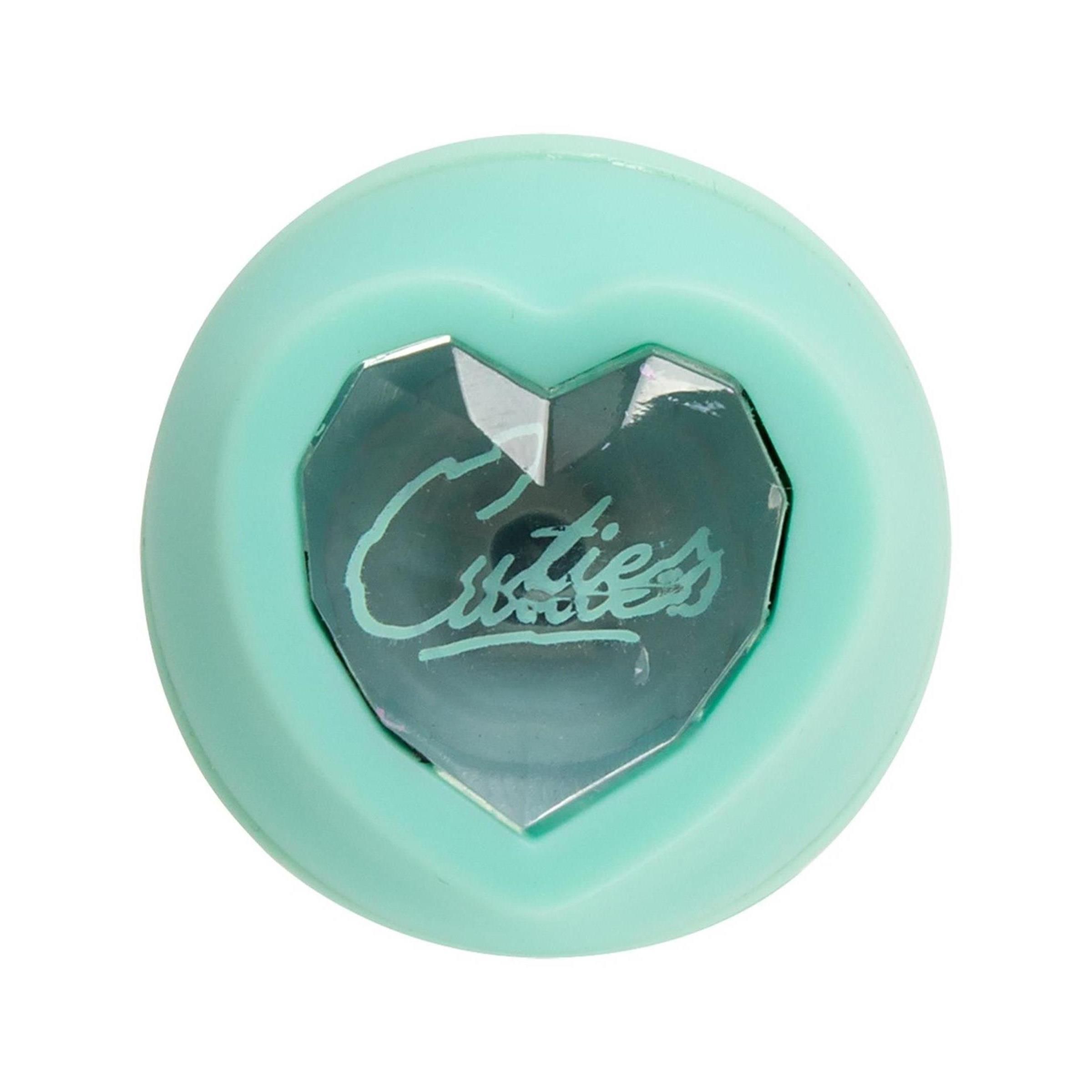 Mintgrüner Minivibrator-Boden. Herzförmige Basis mit einem Kristall in der Mitte und dem Schriftzug 'Cuties'.