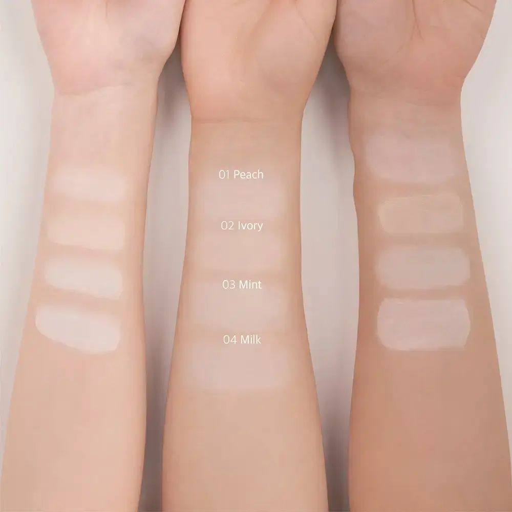 Make-up-Grundierungsproben auf Armen. 01 Peach, 02 Ivory, 03 Mint, 04 Milk. Verschiedene Hauttöne.