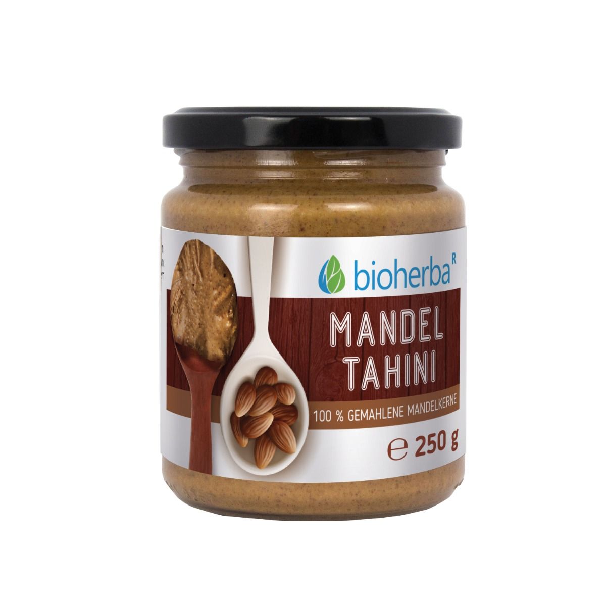 Glas mit Mandel Tahini. Schwarzer Deckel. Etikett mit Logo, Produktname, 100% gemahlene Mandeln, 250 g.