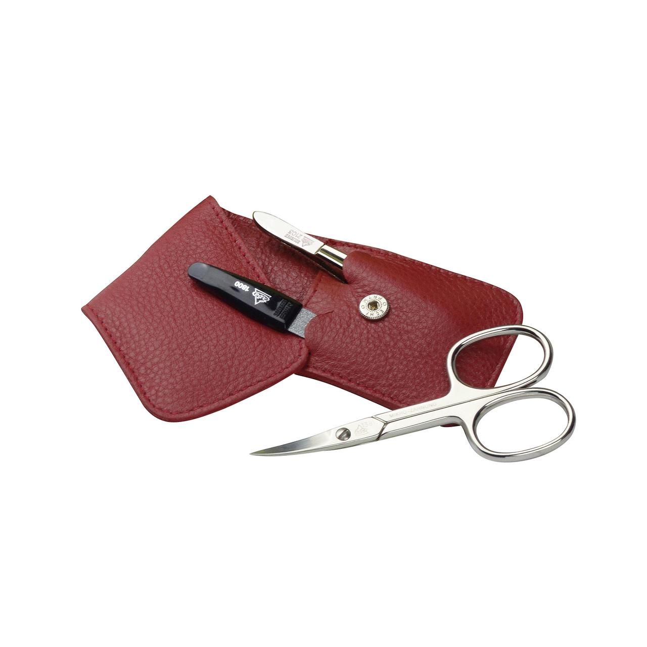 Etui mit Nagelschere, Pinzette und Nagelknipser. Rotes Lederetui mit Druckknopfverschluss. Vernickelte Schere.