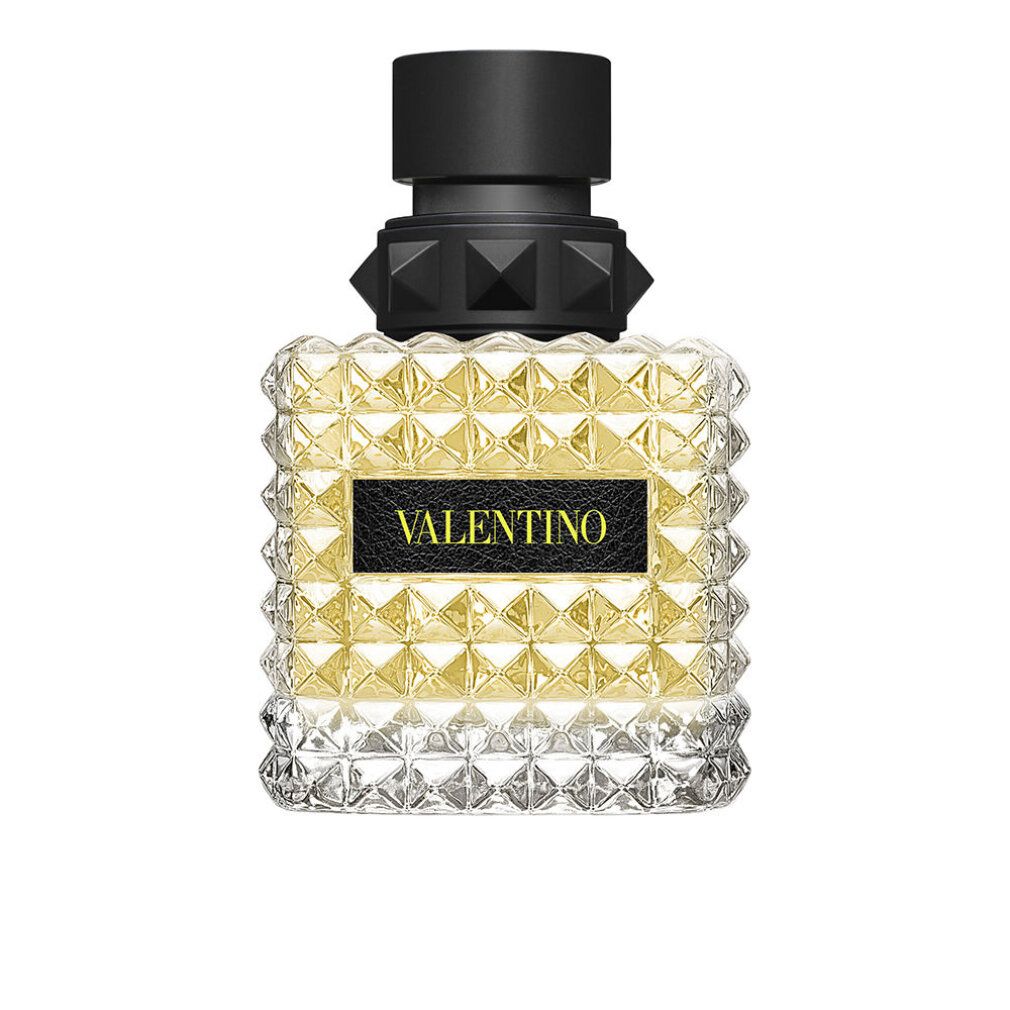 Flakon mit schwarzem Verschluss und quadratischem Design. Aufschrift: VALENTINO. Flakon mit gelber Flüssigkeit.