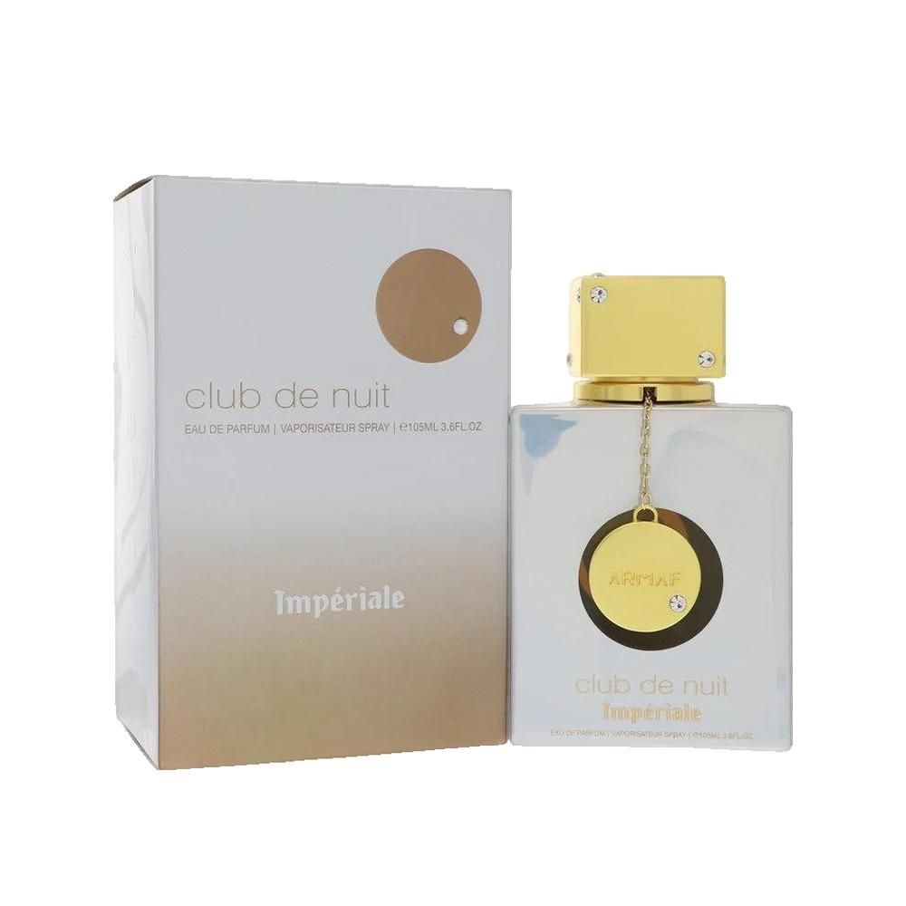 Parfümflakon und Verpackung. Flakon quadratisch, hell, goldener Deckel. Verpackung weiß mit goldfarbenem Kreis und Schriftzug.