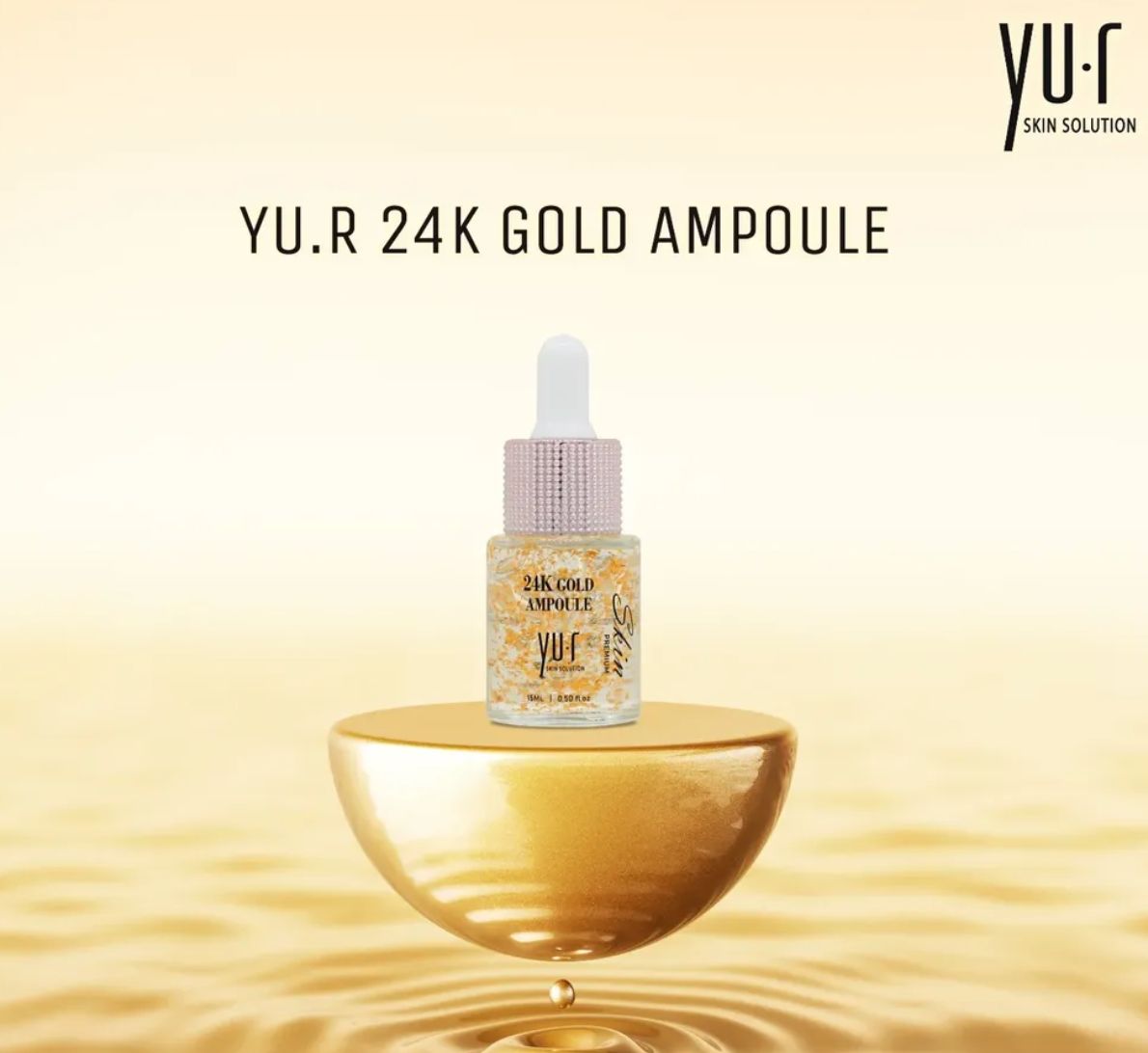 Serumflasche mit Goldflocken auf goldfarbenem Podest. Aufschrift: Yu.R 24K Gold Ampoule.