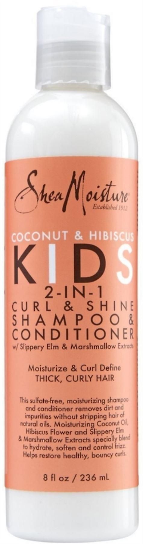Flasche Shea Moisture Kinder Shampoo & Spülung. Orangefarbener Aufdruck mit Produktnamen und Inhaltsangaben. Weiße Kappe.