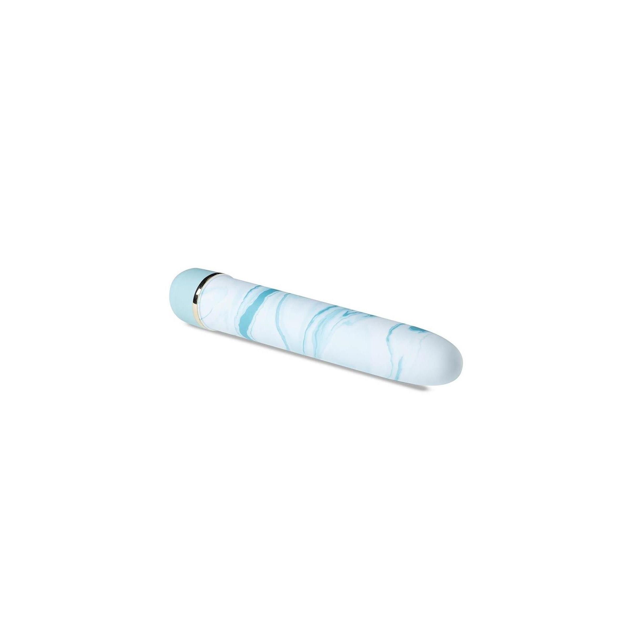 Zylindrisches Wellness-Produkt mit blau-weißem Marmormuster. Abgerundete Enden, goldfarbener Ring.