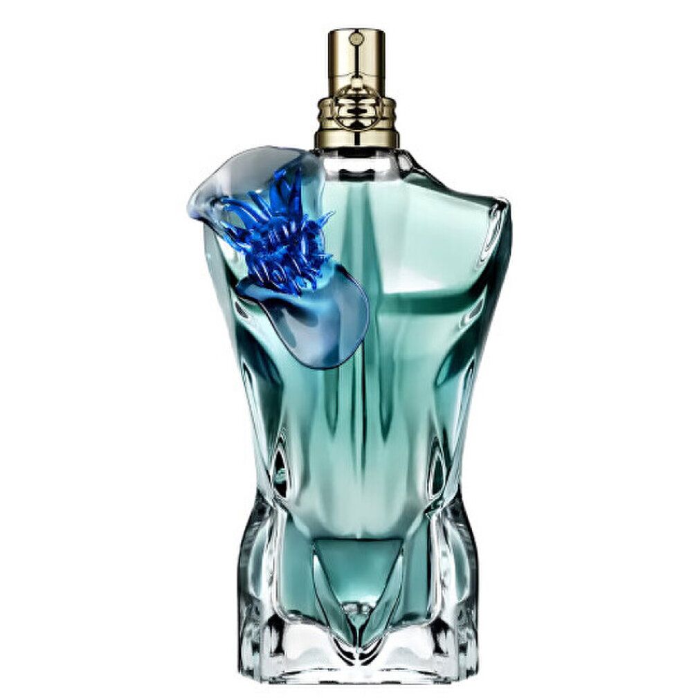 Türkisgrüner Flakon in Torsoform mit blauem Blütenaufsatz. Goldfarbener Sprühkopf.