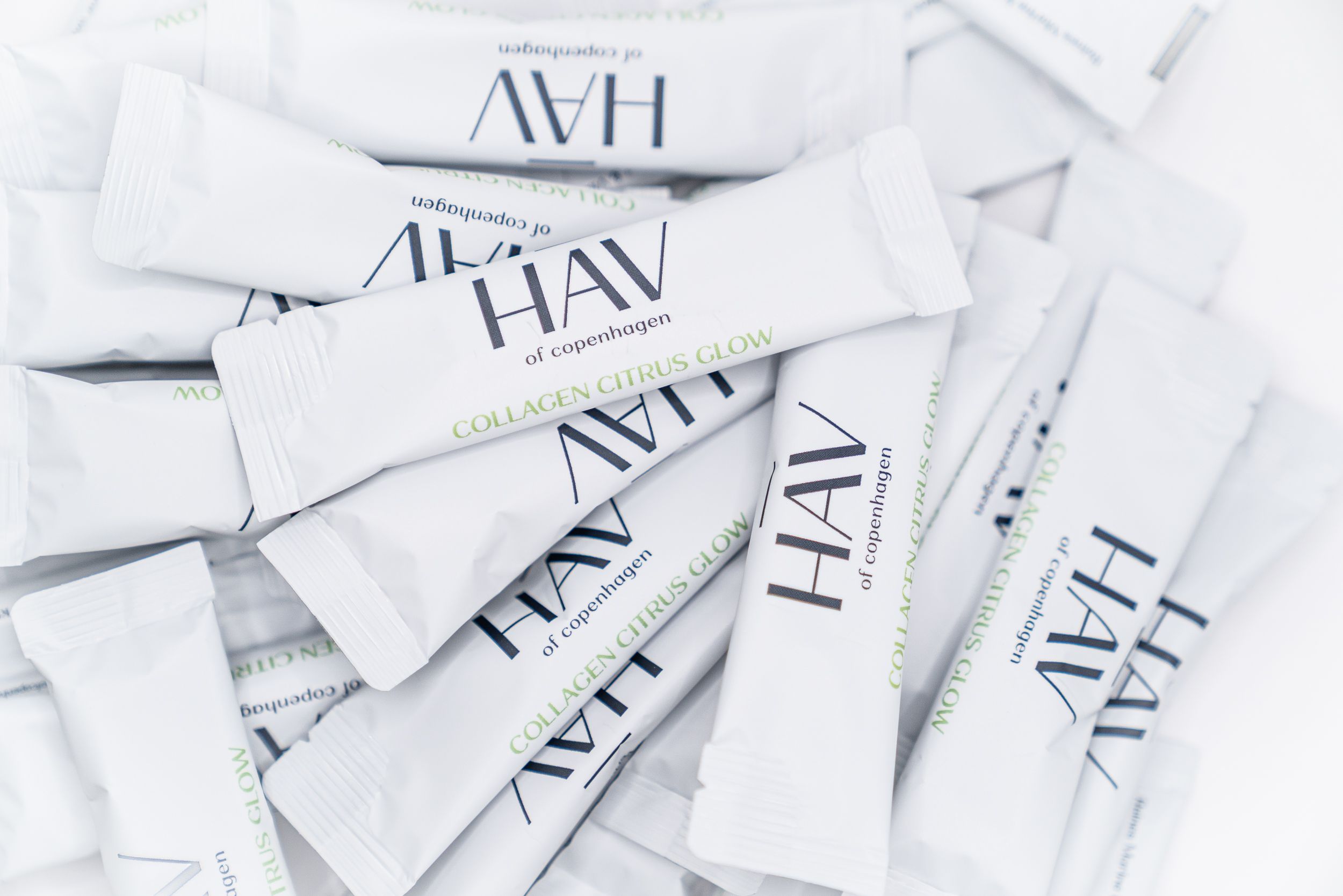 Haufen von weißen Sticks mit HAV of Copenhagen Collagen Citrus Glow. Logo und Produktname auf jedem Stick.