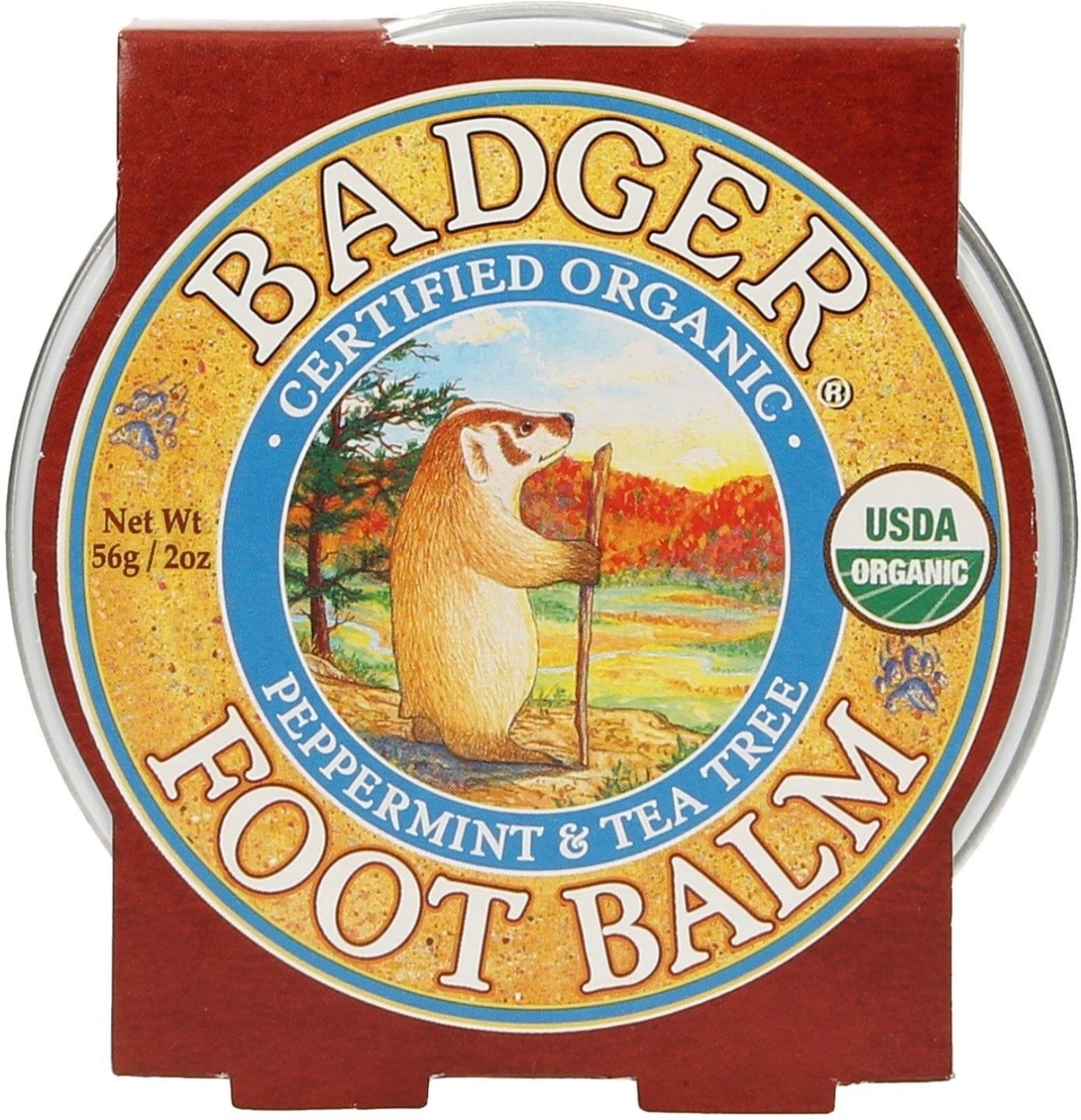 Boîte ronde avec emballage marron. Inscription: BADGER FOOTBALSAM. Image d'un blaireau avec bâton de marche. Label USDA Organic.