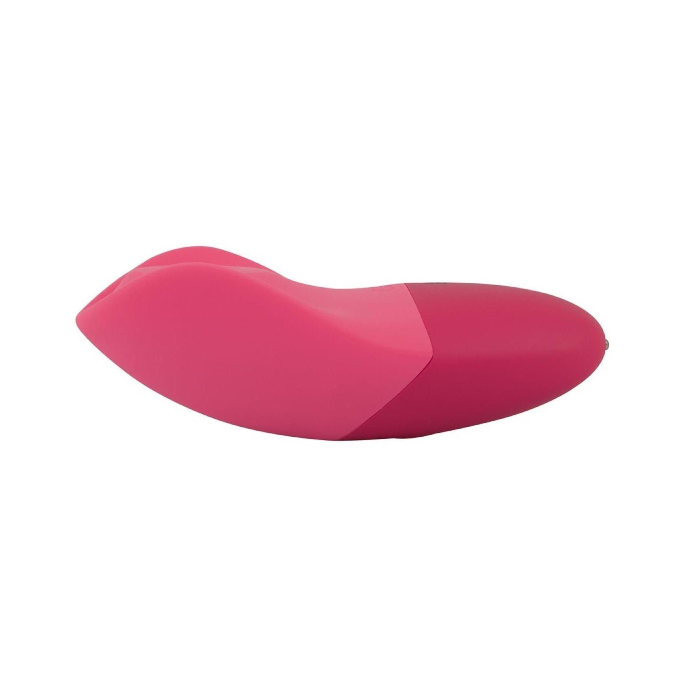 Rosa Vibrator, flache Form. Zwei farbliche Bereiche. Unterseite mit zwei kleinen Punkten.