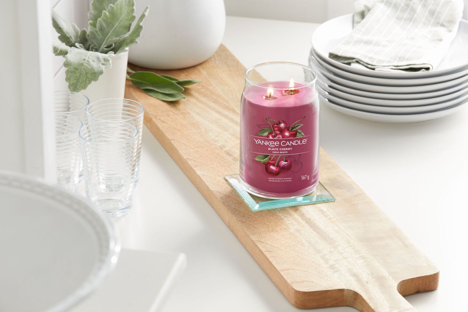 Yankee Candle Black Cherry auf Holzbrett. Glas, brennend. Kirsch-Illustration. Teller, Gläser.