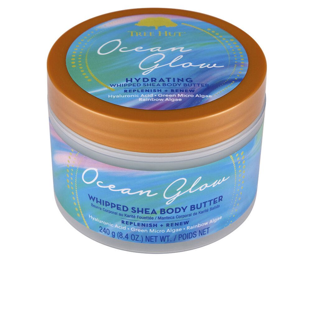 Tree Hut Ocean Glow Whipped Shea Body Butter in einem durchsichtigen Behälter mit orangefarbenem Deckel und Etikett.